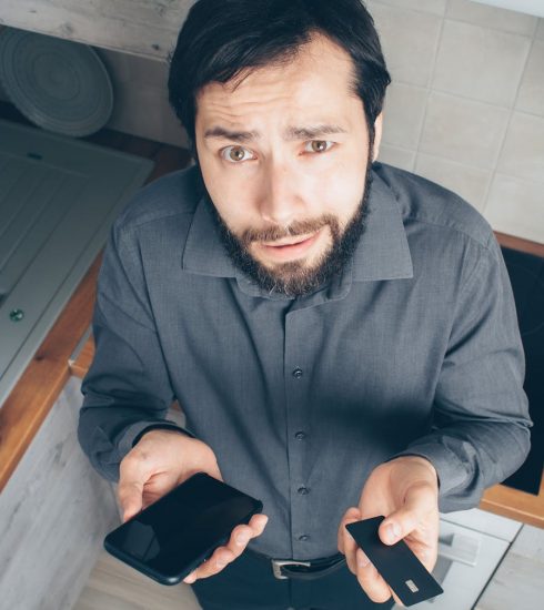 Man in Black Dress Shirt Holding Black Smartphone